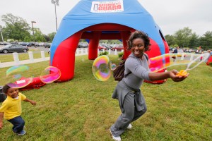20090529TK 1/x Patricia Young of Freehold keeps her 3 year old son Cristian (cq) occupied with some bubbles as they wait for Patricia's husband Staff Sgt. Harry Young of the New Jersey National Guard 50th Infantry Brigade Combat Team to arrive home at Fort Dix after a year in Iraq. FORT DIX, NJ 5/29/09 1:51:30 PM TONY KURDZUK/THE STAR-LEDGER