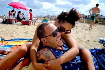 Grace Sabbagh, from Washington Twp. and Jose Ortiz, from Philidelphia, enjoy relaxing on the Belmar Beach Thursday afternoon. People enjoy the nice weather on the 4th of July holiday. (Aristide Economopoulos/The Star-Ledger)
